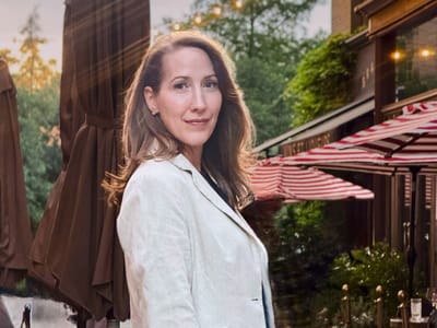 Erin Warner outside a café in a white blazer