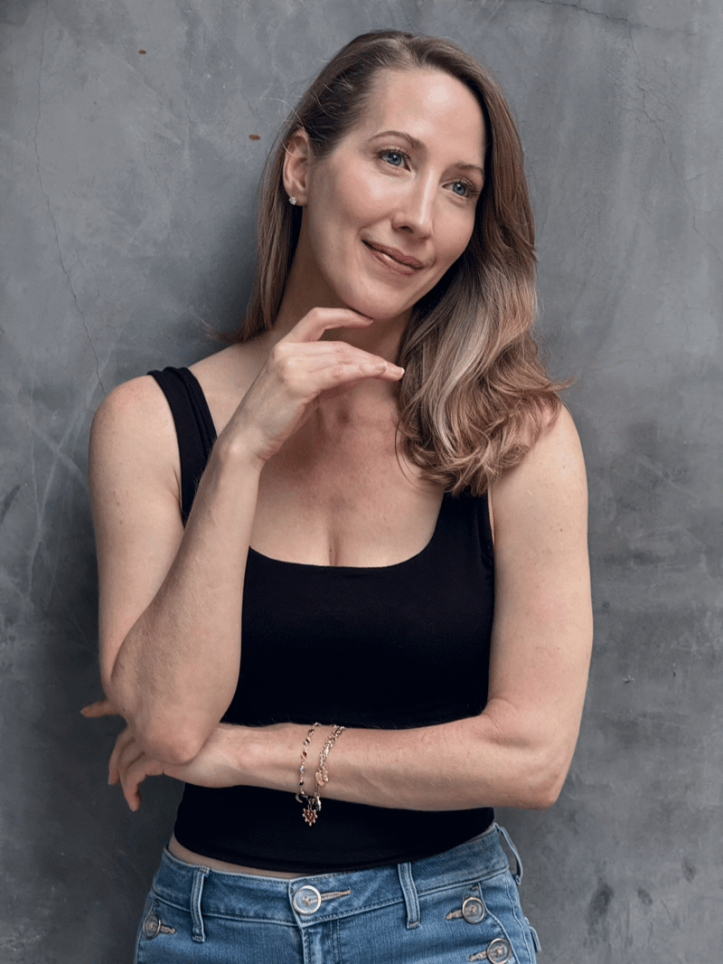 Erin Warner smiling with her hand resting on her chin