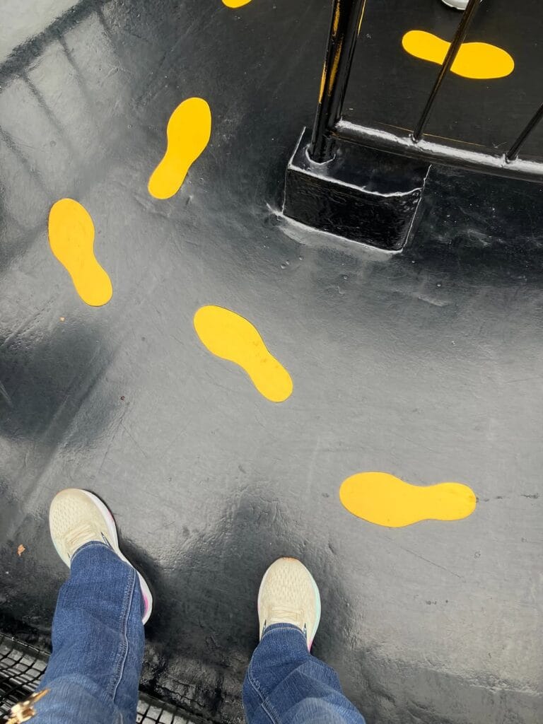 Yellow footprint markers on the floor of an interactive art installation at Hakone Open Air Museum, Japan
