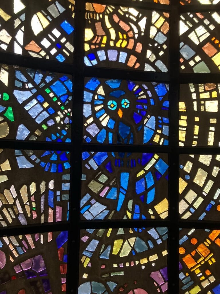 Stained glass mosaic detail inside the Symphonic Sculpture at Hakone Open Air Museum featuring an owl in blue and gold